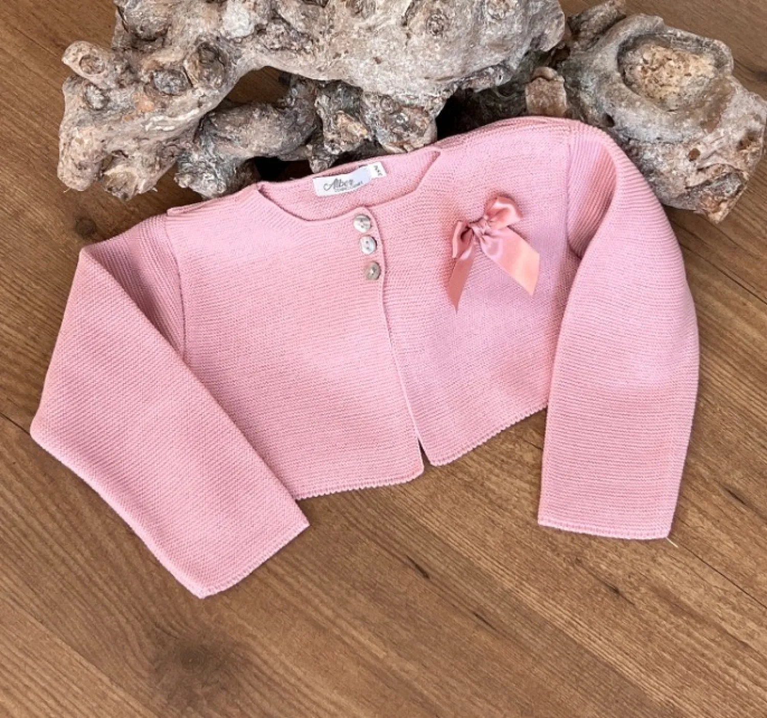 Girl's jacket in fine yarn, three colors with matching bow.